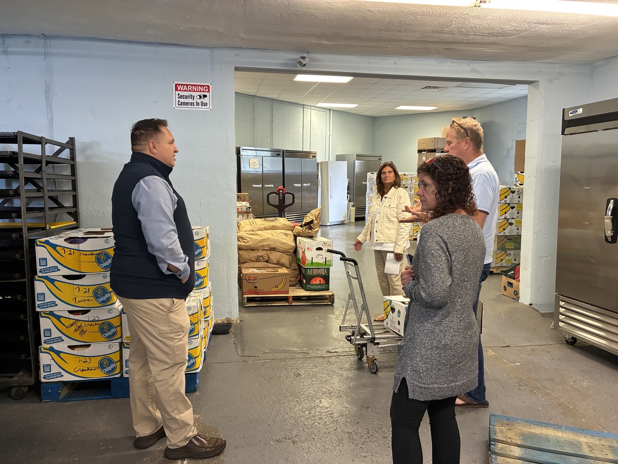 Justin Thurber touring a community food pantry storage facility