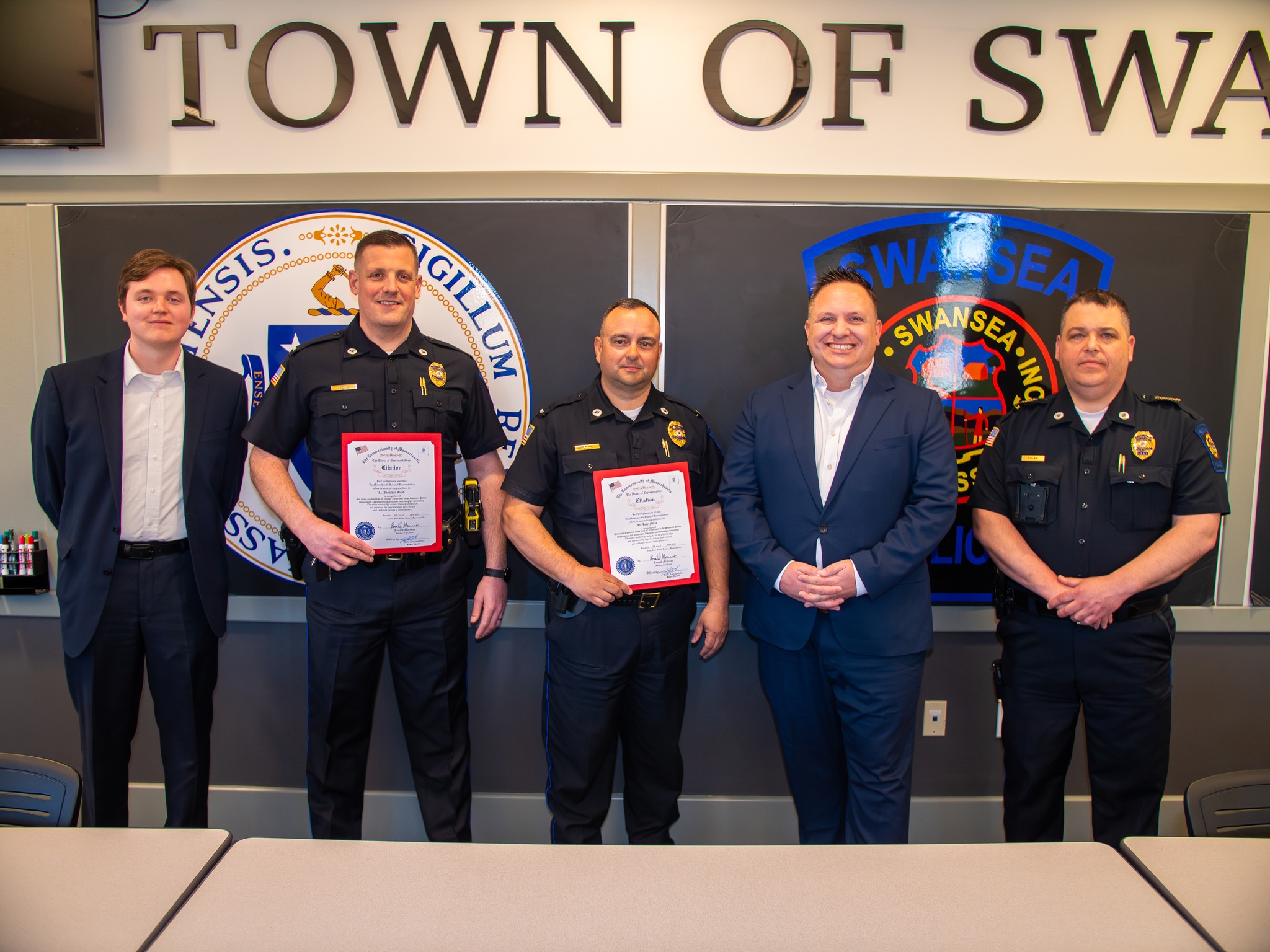 Justin Thurber presenting citations to Swansea Police officers